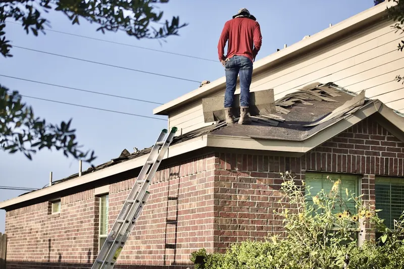 Professional roofer working on a residential roof in Woodlake - Briar Meadow
